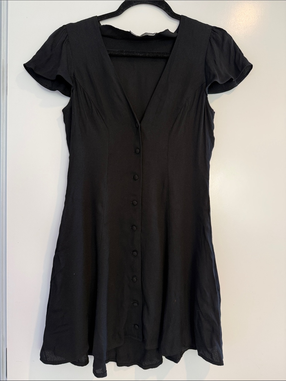 Reformation short black flutter dress with soft cap sleeves and buttons